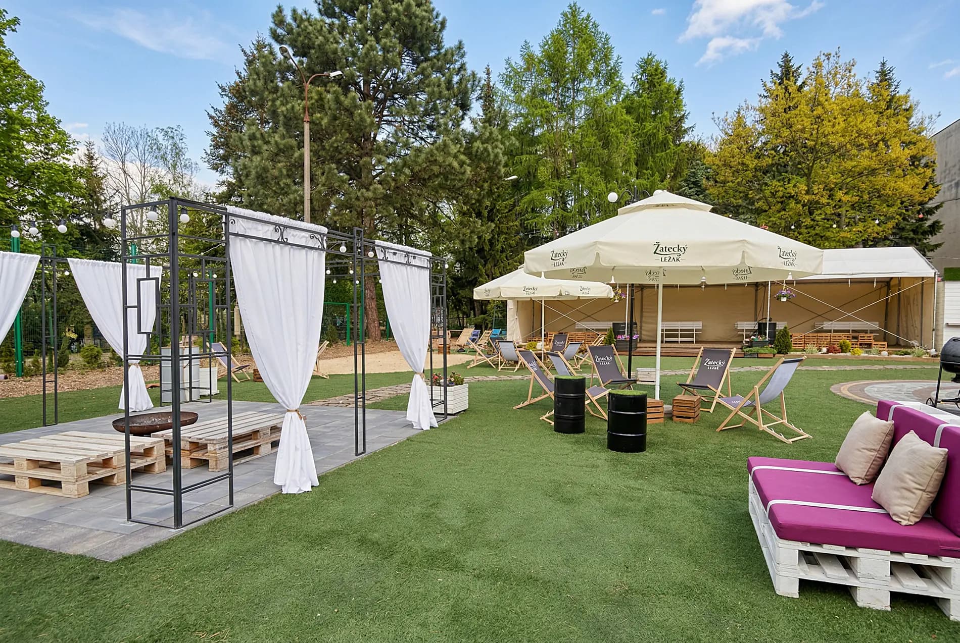 Strefa relaksu na świeżym powietrzu — meble ogrodowe, parasole i leżaki w parku